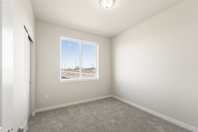 unfurnished bedroom featuring a closet, carpet flooring, and baseboards