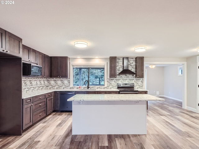 kitchen with built in microwave, dishwasher, wall chimney range hood, stainless steel electric range, and a kitchen island