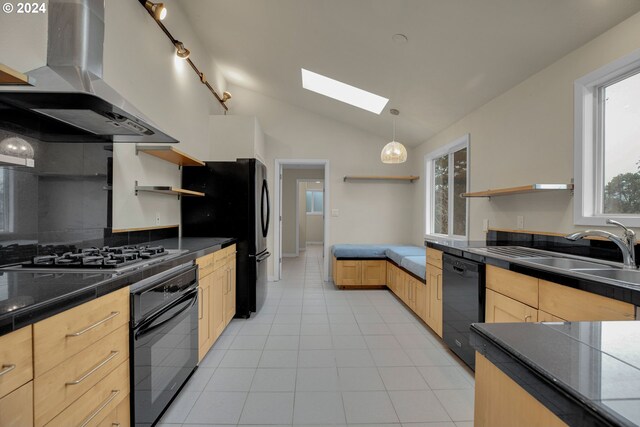 kitchen featuring island range hood, black appliances, lofted ceiling with skylight, light brown cabinetry, and sink