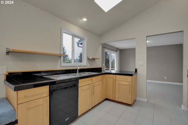 kitchen featuring vaulted ceiling, light brown cabinetry, dishwasher, and sink