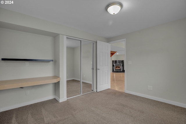 unfurnished bedroom featuring carpet floors and a closet