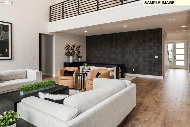 living room with hardwood / wood-style flooring and a high ceiling