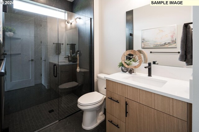 bathroom featuring vanity, a shower with shower door, toilet, and tile patterned flooring