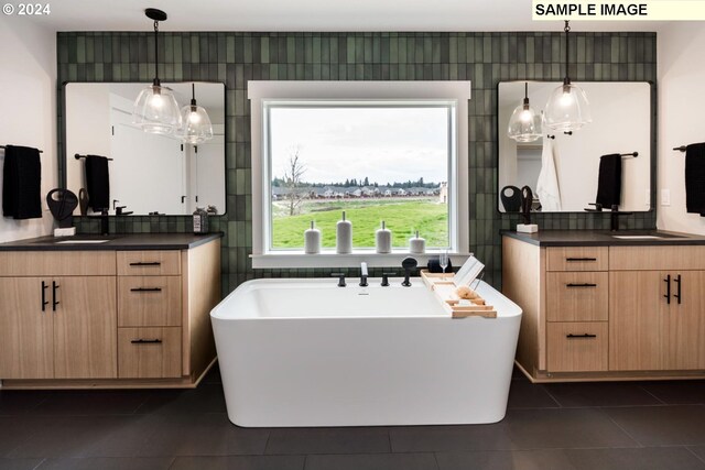 bathroom featuring vanity, a bathing tub, and tile patterned floors