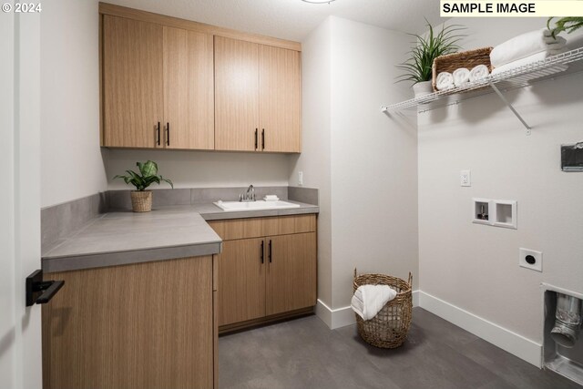 laundry area with washer hookup, sink, hookup for an electric dryer, and cabinets