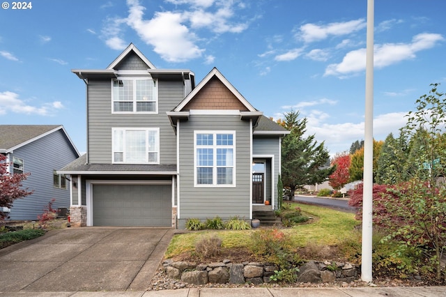 craftsman house with central AC unit and a garage