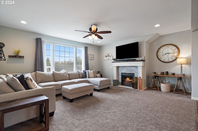 living room featuring ceiling fan, carpet flooring, and a fireplace