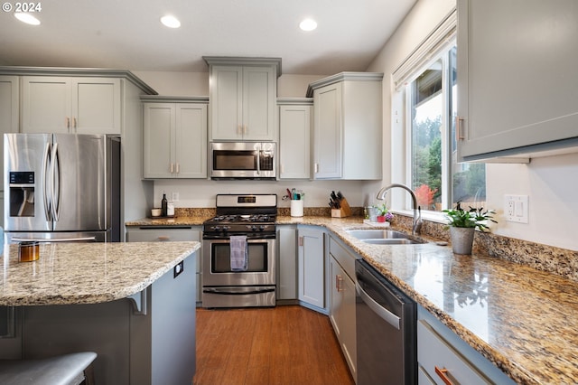 6905 Flicker Dr SE, Salem, OR 97306 - kitchen featuring appliances with stainless steel finishes, a sink, gray cabinets, recessed lighting, and light stone countertops