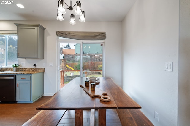 dining space with light hardwood / wood-style flooring and a notable chandelier