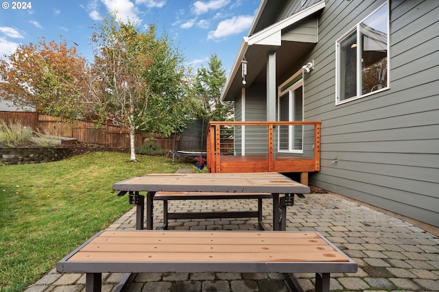 wooden deck featuring a yard and a trampoline