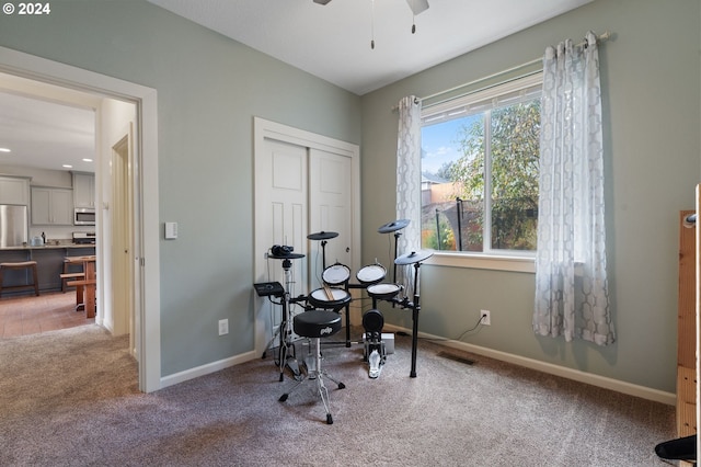 exercise area featuring carpet floors and ceiling fan