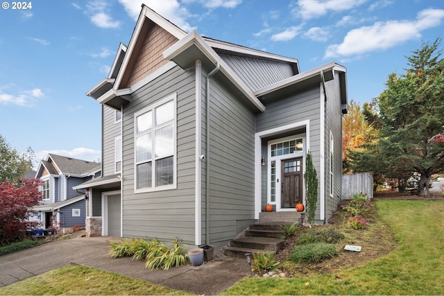 view of front facade with a garage and a front lawn