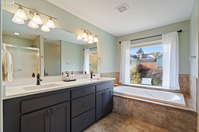 bathroom featuring vanity, tile patterned floors, and separate shower and tub