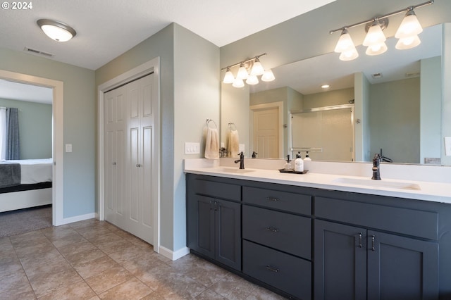 bathroom with vanity, walk in shower, and tile patterned flooring