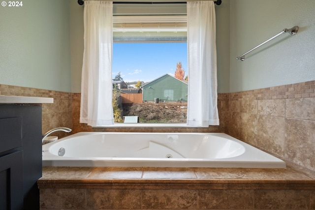 bathroom with a relaxing tiled tub