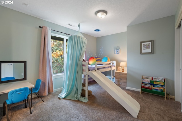 carpeted bedroom with a textured ceiling