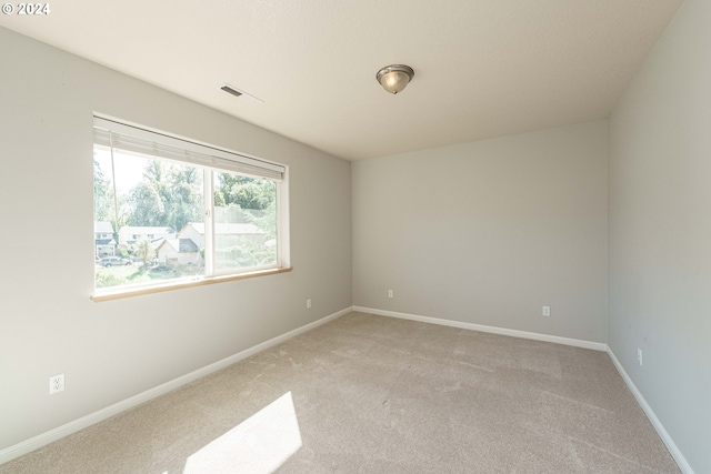 empty room featuring light carpet