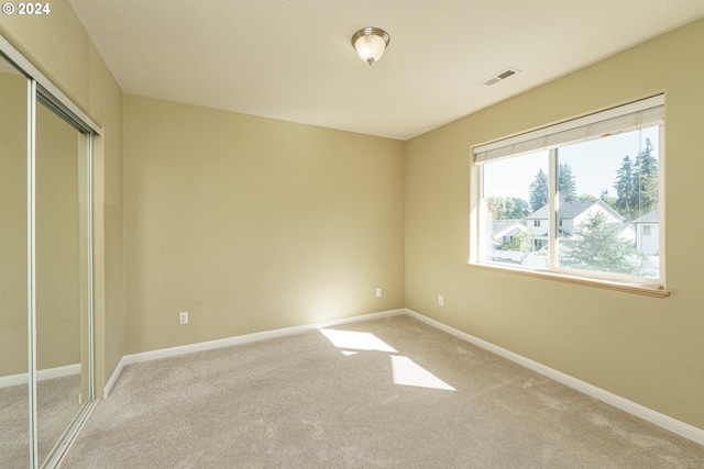 unfurnished bedroom featuring a closet and carpet flooring