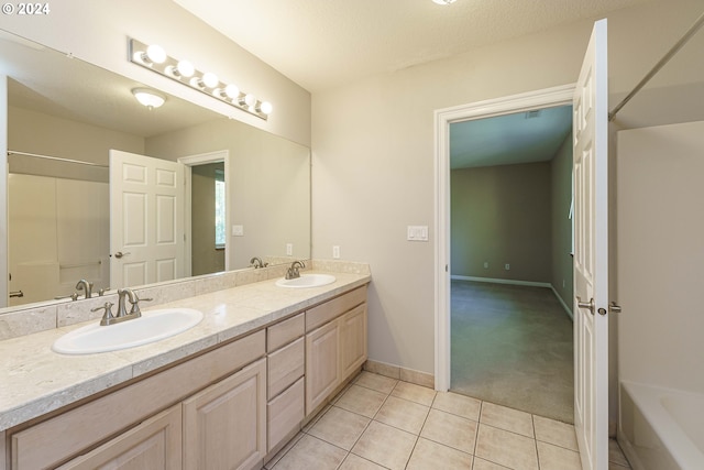 bathroom with vanity, shower / washtub combination, tile patterned flooring, and a textured ceiling