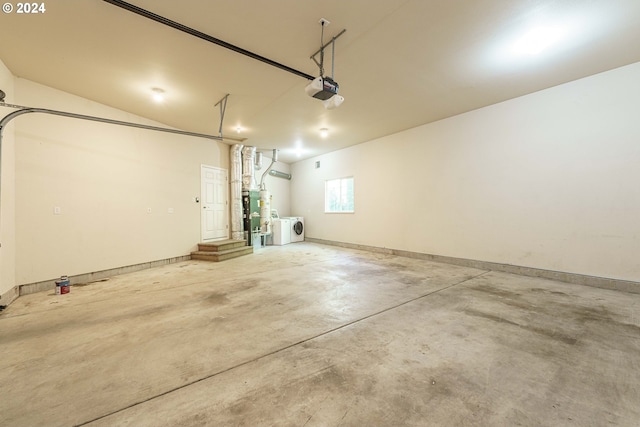 garage with a garage door opener and washer and clothes dryer