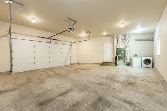 garage with a garage door opener, washer and dryer, and secured water heater