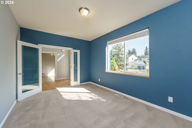 unfurnished bedroom with light colored carpet