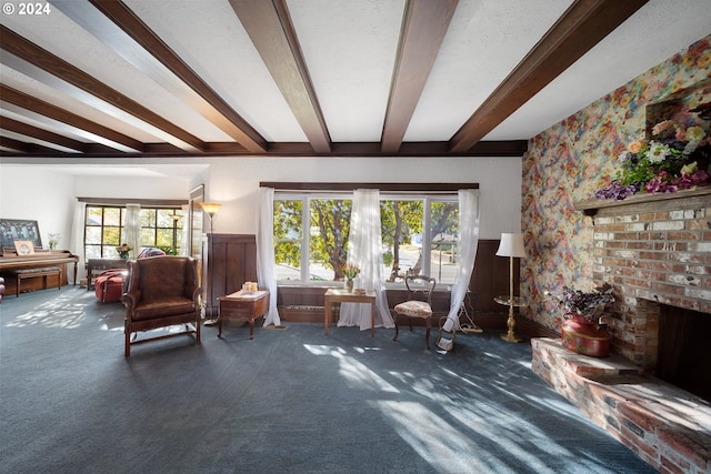 living room with beamed ceiling, dark colored carpet, and a fireplace