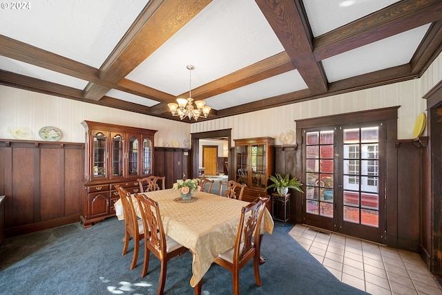 dining room with beam ceiling, coffered ceiling, and light tile patterned floors