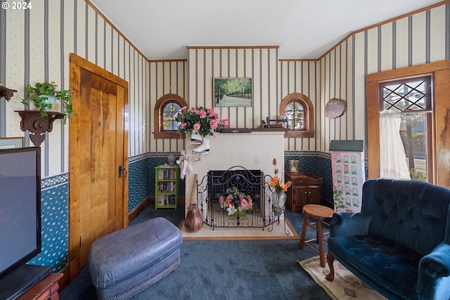 sitting room with a fireplace and carpet