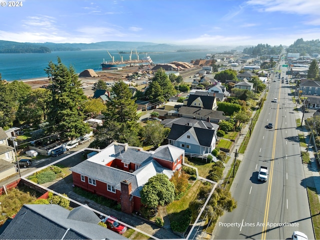 drone / aerial view with a water and mountain view