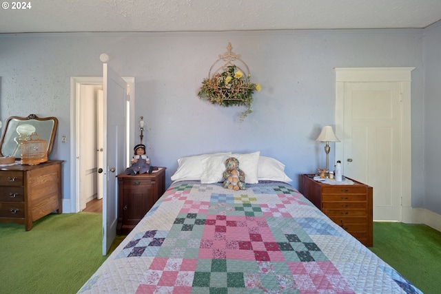 bedroom with carpet floors and a textured ceiling