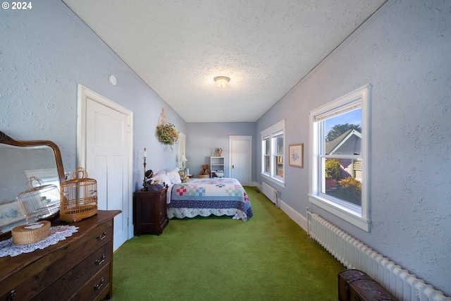 carpeted bedroom featuring radiator, a textured ceiling, and ornamental molding