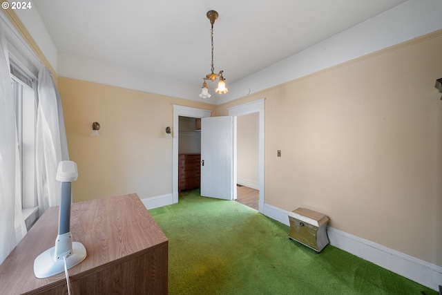 interior space with an inviting chandelier, carpet flooring, and a healthy amount of sunlight