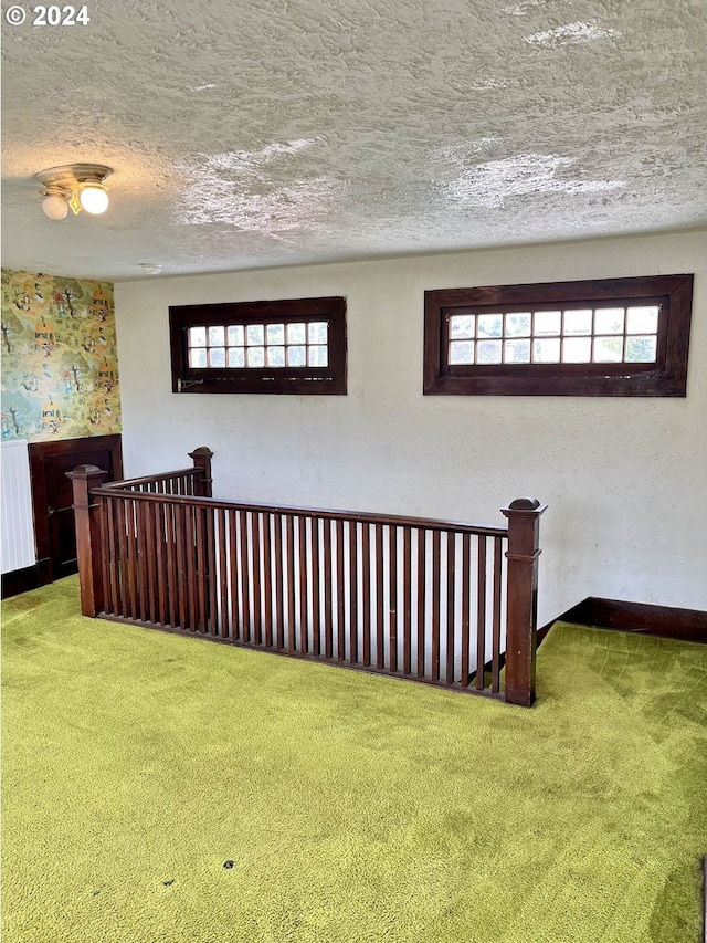 interior space featuring a textured ceiling and carpet