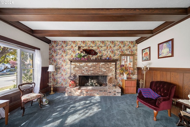 sitting room featuring a fireplace, wooden walls, carpet, and beam ceiling