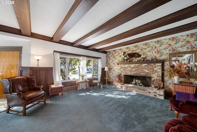 carpeted living room with beamed ceiling, wooden walls, a textured ceiling, and a fireplace