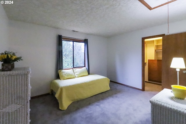 carpeted bedroom with a textured ceiling