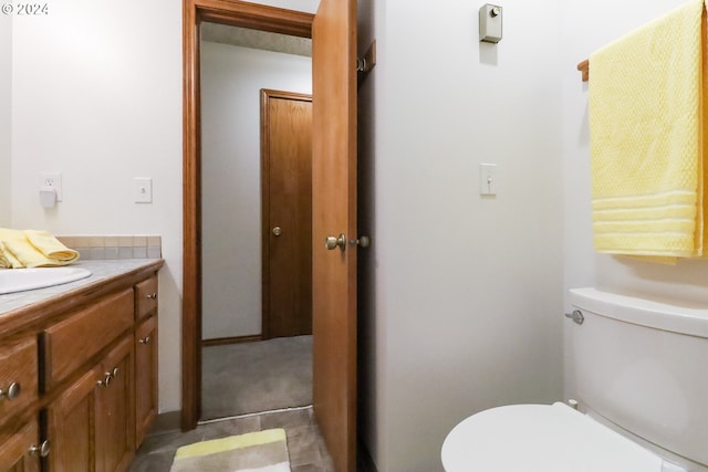 bathroom featuring tile patterned floors, vanity, and toilet