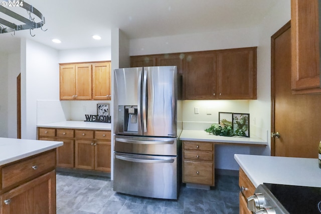 kitchen with stove and stainless steel fridge with ice dispenser