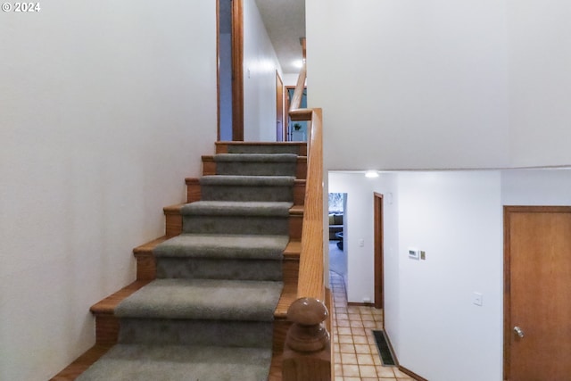 stairway featuring tile patterned flooring