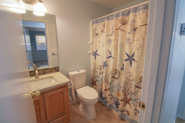 bathroom featuring vanity, curtained shower, toilet, and tile patterned flooring