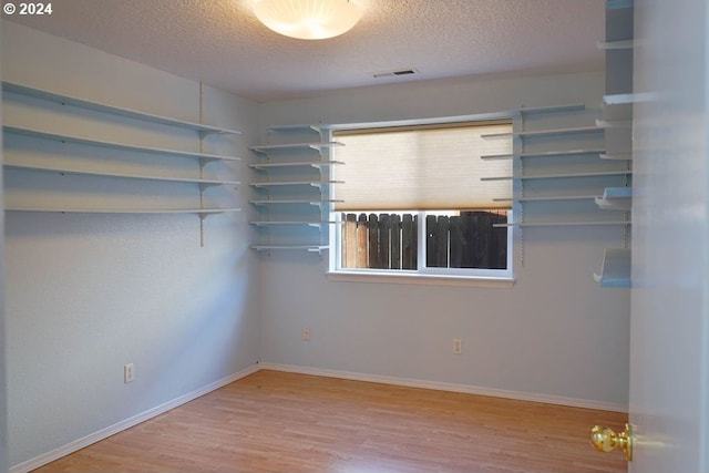 spare room with hardwood / wood-style flooring and a textured ceiling