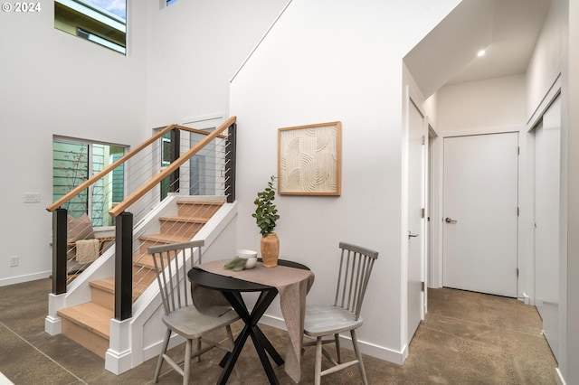 dining area featuring a high ceiling