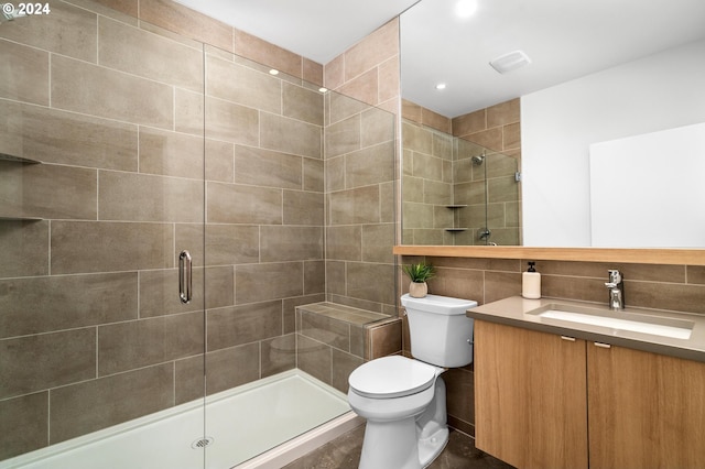 bathroom featuring toilet, walk in shower, and vanity