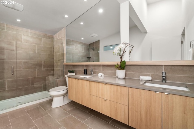 bathroom with toilet, tile patterned flooring, vaulted ceiling, vanity, and an enclosed shower