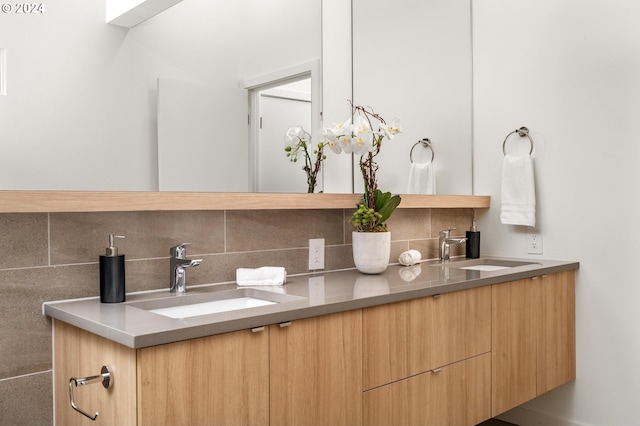 bathroom featuring vanity and backsplash