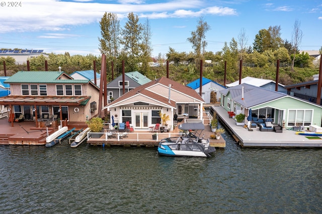 rear view of house featuring a patio area and a water view