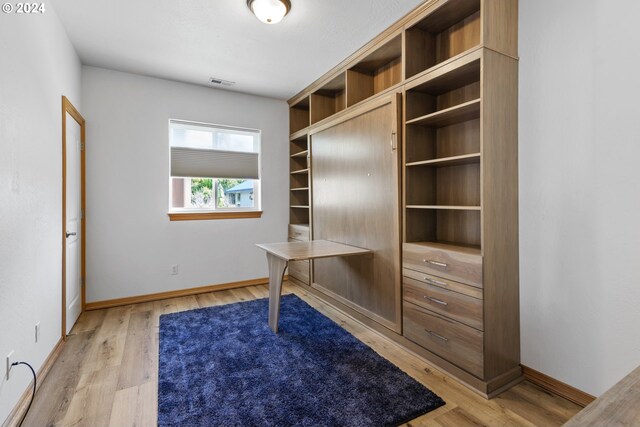 unfurnished office with light wood-type flooring