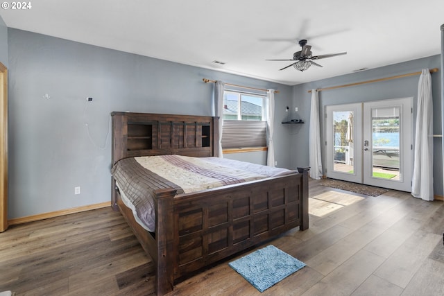 bedroom with ceiling fan, access to exterior, multiple windows, and wood-type flooring