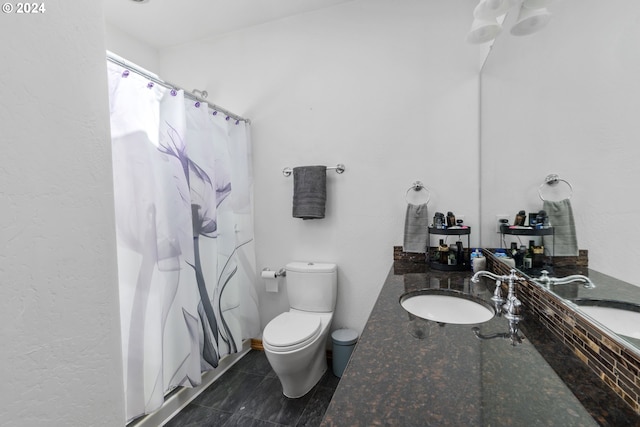 bathroom with walk in shower, vanity, and toilet